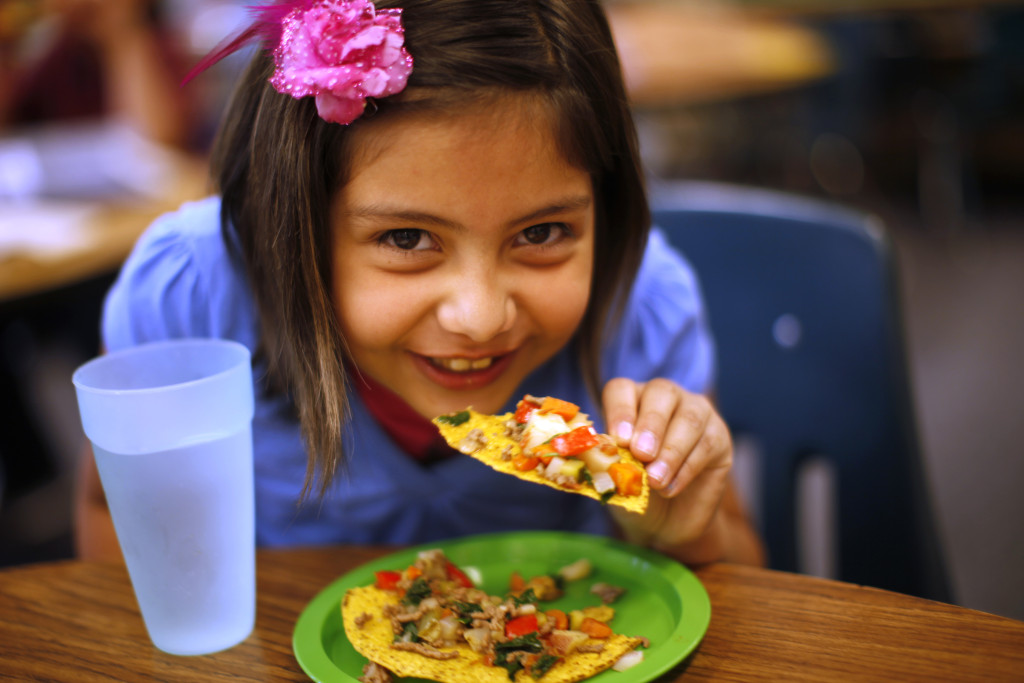 Ruby Mendoza, a student in the Munroe Elementary School gardening club enjoys a meal she helped prepare by growing and chopping vegetables at the school in Denver
